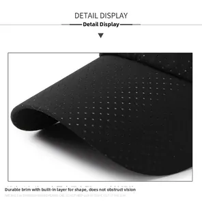 Detail of sturdy curved brim on black breathable baseball cap with fine stitching