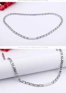 Detailed close-up of a stainless steel necklace with engraved rectangular BERCIAN nameplate