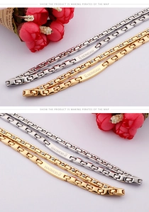 Detail of stainless steel germanium bracelet with gold and silver links and logo engraving
