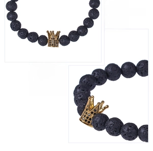 Macro shot of gold crown charm with micro-inlaid black zircon on lava stone bracelet