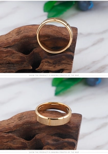 Detail of gold-plated stainless steel ring with brushed surface and vertical grooves