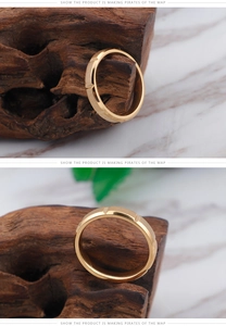 Close-up of gold-plated ring with brushed sand finish and polished edges on marble
