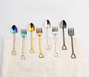 Close-up of shovel-shaped stainless steel spoons and forks in four metallic finishes