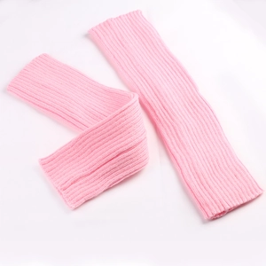 Close-up of pink ribbed knit leg warmers with soft thermal texture on white background