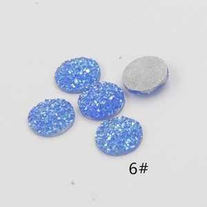 Close-up of 12mm blue resin druzy cabochons with sparkling texture and flat silver back