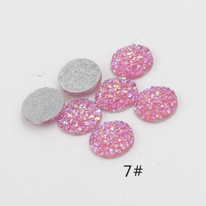 Detailed view of 12mm pink resin rhinestones with glitter finish for DIY crafts