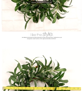 Detail showing artificial olive leaf wreath dimensions with a yellow measuring tape