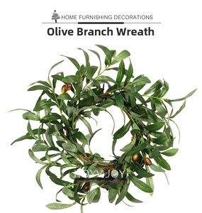 Detail of faux olive wreath with realistic leaves, berries, and woven vine base