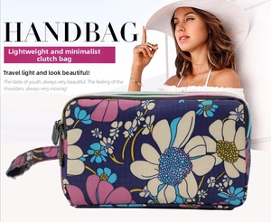 Close-up of floral print long wallet with three zipper layers and a wrist strap