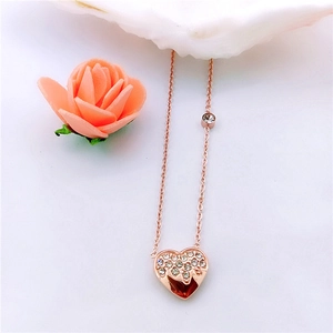 Detail of rose gold melting heart necklace with zircon inlay and small round stone