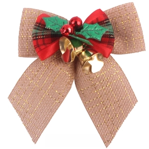 Detail of Christmas burlap bow with gold thread, red plaid, berries and golden bells