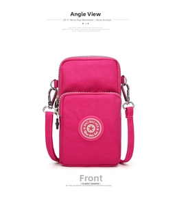 Detail view of pink nylon mobile phone bag featuring dual zippers and adjustable strap