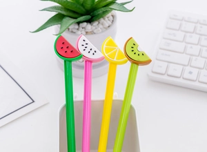Close-up of creative fruit-shaped gel pens featuring watermelon and lemon silicone toppers