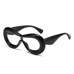 Chunky black oversized eyewear with thick wavy frames and clear blue light lenses