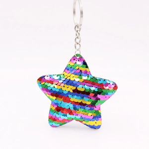Close-up of star shaped sequin keychain featuring reflective rainbow finish and metal ring