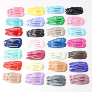 Set of colorful snap hair clips in candy colors arranged in a grid on white background