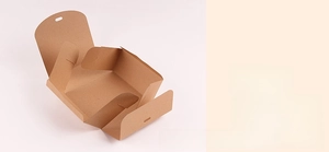 Macro detail of kraft paper gift box showing pre-scored folding lines and assembly steps