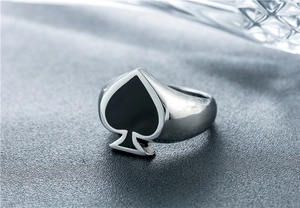 Macro view of vintage spade ace poker pattern engraved on polished stainless steel ring
