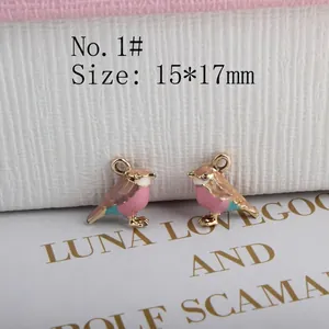 Detail of 15x17mm bird-shaped enamel charms with pink and brown finish for jewelry making