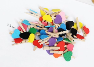 Detail showing colorful wooden mini heart photo clips in various assorted colors