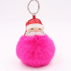 Detail of rose red fluffy pompom keychain with cute Santa Claus plush and metal ring