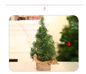 Detailed view of mini green Christmas tree with a rustic natural burlap wrapped base