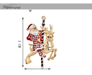 Detail view of a Christmas carousel brooch with Santa, reindeer, and crystal accents