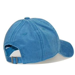 Close-up of washed cotton baseball cap featuring an adjustable strap and bronze buckle