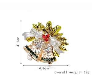 Detail view of a Christmas bell brooch with white bow and red rhinestone berries