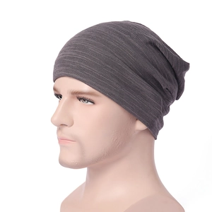 Detail view of the fine texture and stretch of a dark grey slouchy knit beanie hat
