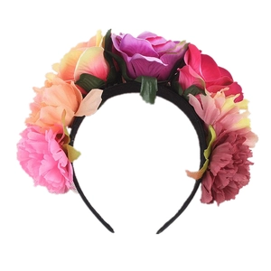 Close-up of vibrant artificial rose and peony flowers on a festive floral headband