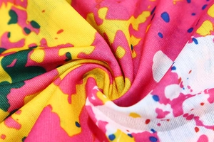 Macro shot of seamless microfiber fabric featuring vibrant abstract ink splash patterns