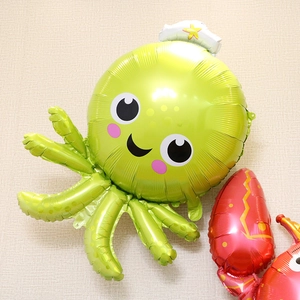 Green cartoon octopus and red lobster foil balloons for sea animal theme birthday parties
