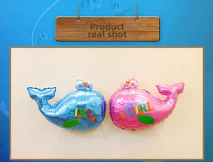 Detailed view of pink and blue whale foil balloons with baby GIRL text for party decor