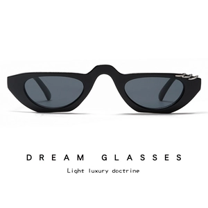Detail showing black cat eye sunglasses with three silver metal rings on the frame