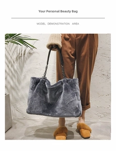 Detail of grey plush faux fur tote bag featuring black chain and leather handles