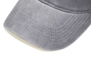 Close-up of vintage grey washed cotton baseball cap brim with multi-row stitching detail