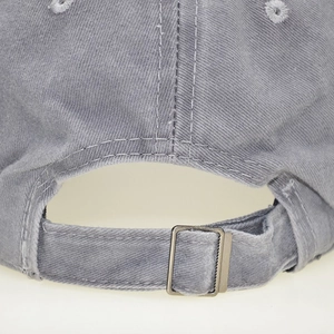 Close-up of adjustable metal buckle and stitching on washed cotton kids baseball cap