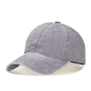 Detail view of grey washed cotton baseball cap with vintage finish and curved brim