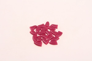 Detail view of flexible rose red silicone pet nail caps for dogs and cats with glue