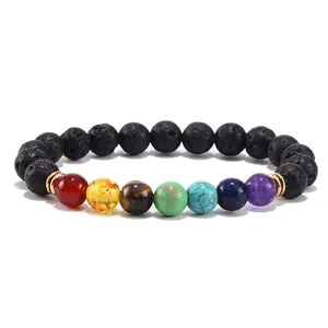 Detailed macro view of seven chakra natural gemstones and black lava rock beads on the bracelet