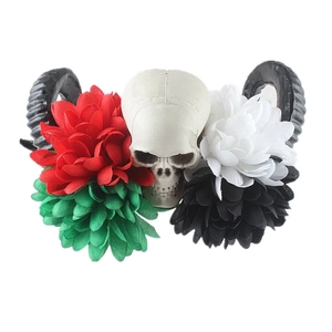Detail of Mexican style gothic headband with skull, black ram horns and colorful roses