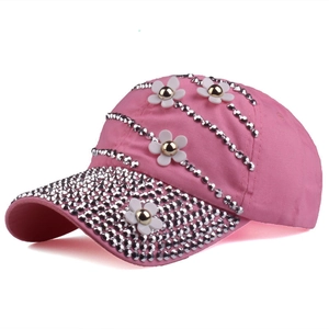 Detail of pink baseball cap with sparkling silver rhinestones and white 3D flowers
