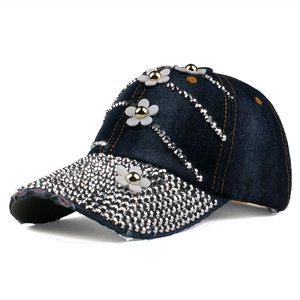Detail of dark blue denim baseball cap with sparkling silver rhinestones and white floral 3D decor