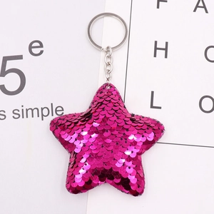 Detail of pink reversible sequin star keychain with silver metal ring and chain
