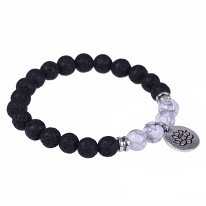 Lava stone bead bracelet with lotus charm and white turquoise on white background