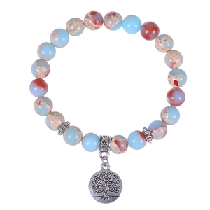 Natural snakeskin stone bead bracelet with silver Tree of Life charm on white background