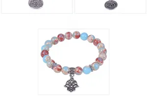 Close-up of blue and brown stone beads featuring a silver Tree of Life and Hamsa pendant