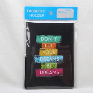 Detail of black passport holder in plastic packaging with an elastic band and quote