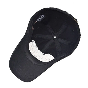 Macro detail of 100% cotton baseball cap interior with wash care label and stitching